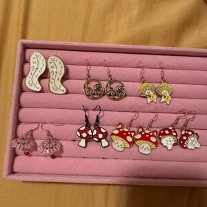 7 sets of Alice in wonderland themed earrings.